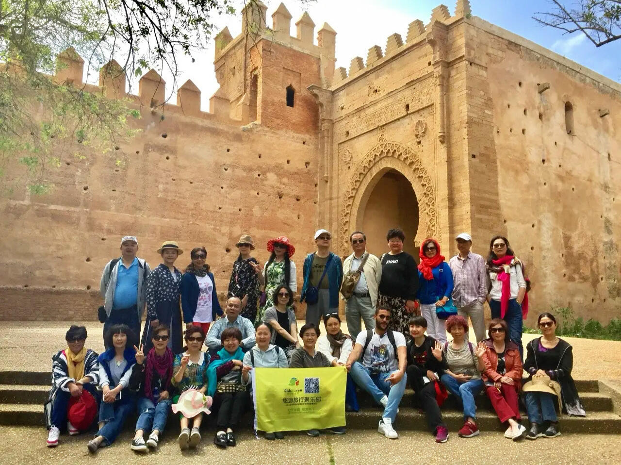 Leading One of 360+ Chinese Tour Groups at Historic Chellah, Rabat Reda Akrime in the middle of 25 Chinese tourists taking a group photo at Chellah in Rabat, Morocco