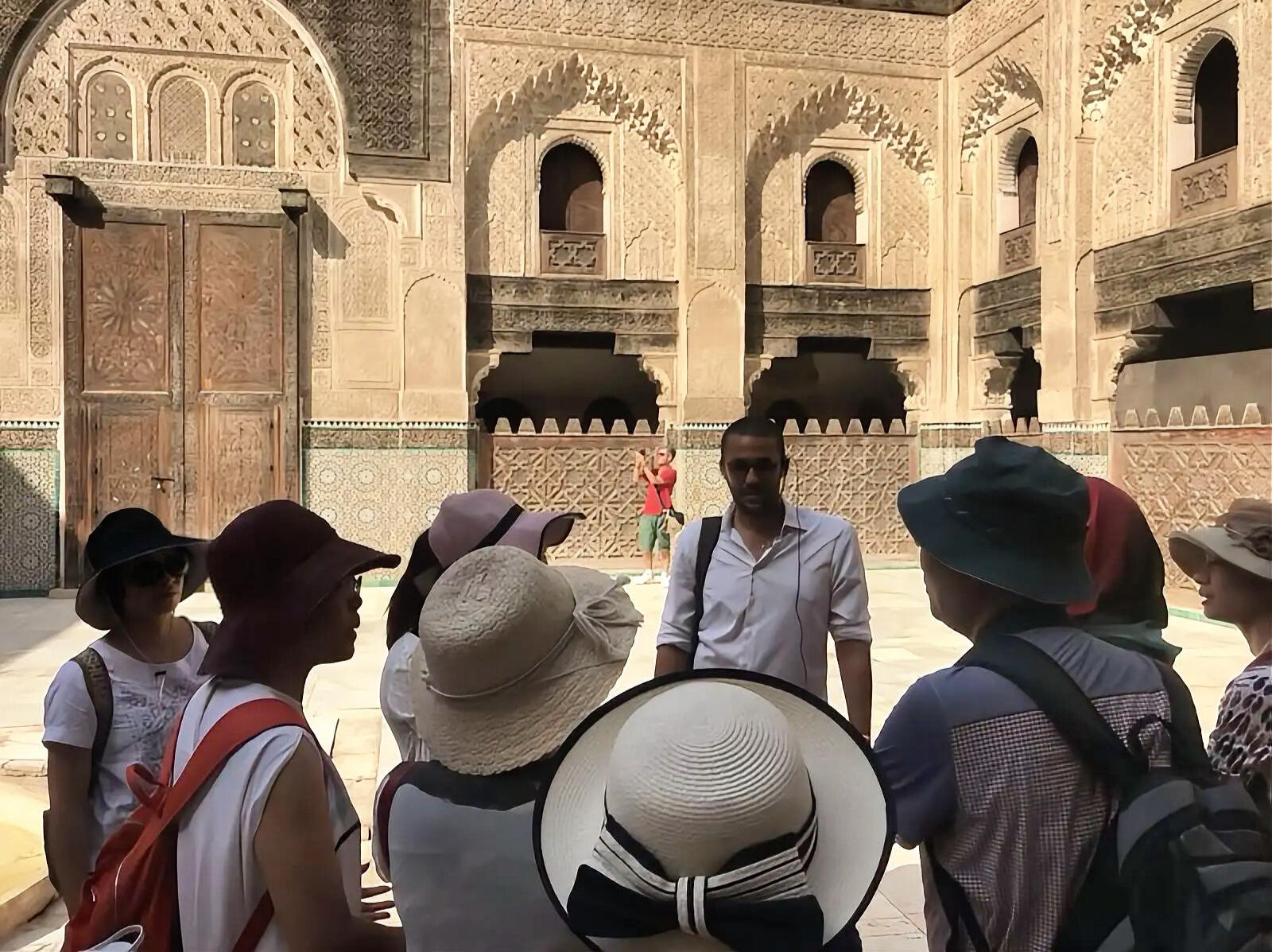 Guiding Chinese Tour Groups at Moroccan Monuments Reda Akrime talking to 7 Chinese tourists at a monument in Morocco